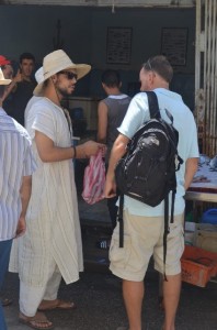 Abderrahmane helping Tom buy fresh fish