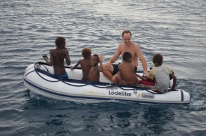 Local kids get Tom to take them for a dinghy ride!