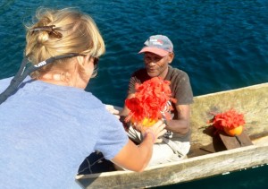 Jonny Ruka welcomes Adina with drinking coconuts decorated with hibiscus flowers